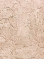Texture of old rustic wall covered with beige stucco