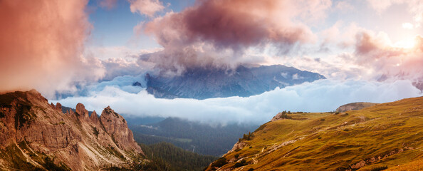 Mountainous terrain with a rocky massif in the Italian Alps in the early morning. South Tyrol,...