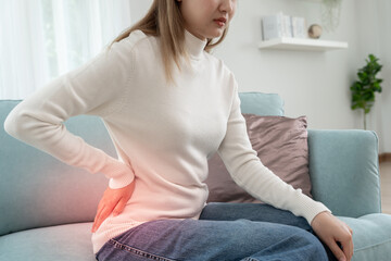  woman holding her lower back while and suffer from unbearable pain health and problems, chronic...