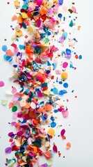 Obraz premium Colorful confetti exploding on a white background for celebration