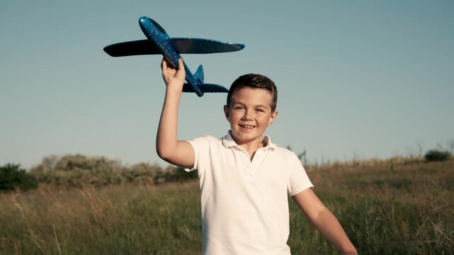 A joyful boy runs through a sunlit field with a toy airplane, embodying the essence of childhood dreams and outdoor play. Ideal for themes of aspiring to be a pilot and carefree days.