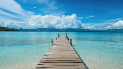 Fototapeta premium A tranquil island scene with a wooden pier extending into clear blue waters, creating a peaceful getaway vibe