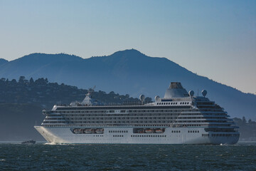 Luxury cruiseship cruise ship liner Serenity sail away departure from San Francisco port through...