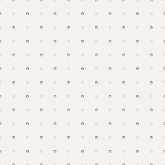 Minimalist pattern with small black horseshoe icons evenly spaced on a light beige background.