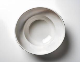 A white ceramic bowl with a smooth, matte finish, placed on a white background