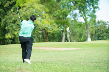 Man is playing golf in morning.