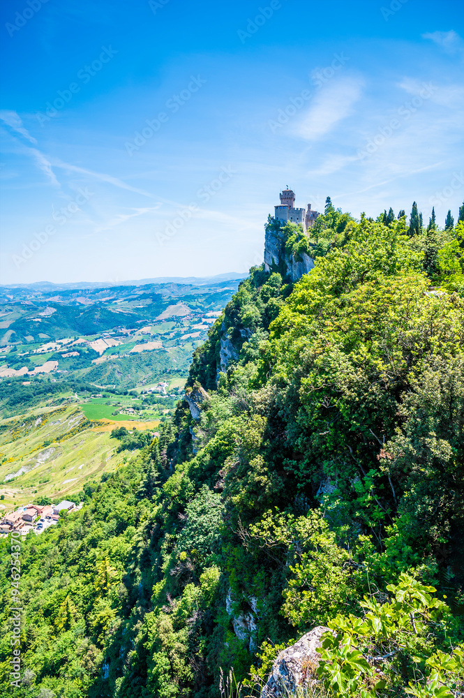 Wall mural a view along the cliff edge towards the second tower in the fortified section of san marino, italy i