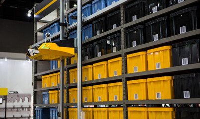 Autonomous robot picking materials from multi-layer rack in modern industrial warehouse.