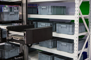 Vertical storage ergonomic solution. Automated storage and retrieval system. Modern industrial warehouse.	