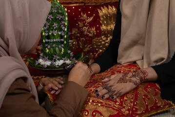 The process of painting henna on the bride's hands. There are many different names for henna tattoo...