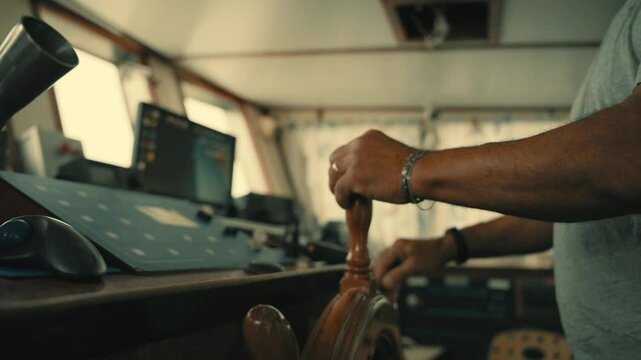  Captain hands control the helm of a boat on the high seas 
