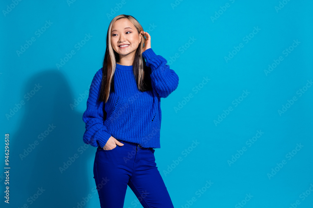 Canvas Prints portrait of young sweet model chinese woman in blue knitted sweater touching her dyed beautiful hair