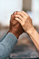 Couple, holding hands and support at table for prayer, trust and faith in religion. Christian people, gesture or growth in spirituality with worship, gratitude or commitment in relationship with love