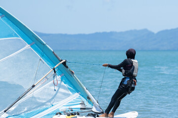 Naklejka premium A windsurfer plays with the wind and ocean waves