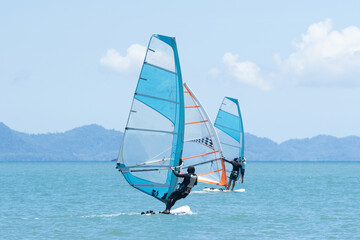 Fototapeta premium Some windsurfers plays with the wind and ocean waves