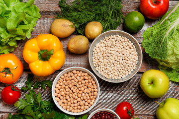 Different vegetarian products on wooden table, top view