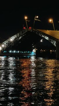 ST. PETERSBURG, RUSSIA - APRIL 20, 2024: View of the drawbridge in the night of St. Petersburg on the embankment of the Neva River. Drawbridges are a famous landmark of the northern city. 4К
