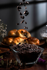 Butter croissants on a wooden plate with ingredients for breakfast or a snack and coffee beans 