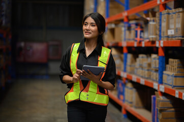 Woman standing holding an iPad, Logistics engineering transportation of import export shipping...