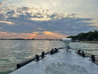 A view of Venice from a boat on the sunset