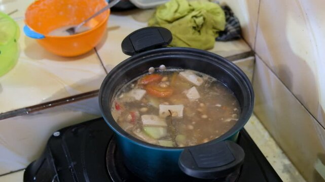 Cooking sour vegetables or tamarind vegetables in a simple kitchen