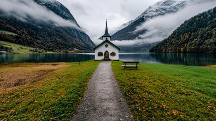 Serene Lakeside Chapel A Picturesque Chapel Nestled by a Tranquil Lake Surrounded by Majestic Mountains Capturing the Peaceful Beauty of Nature and Spiritual Reflection in the Alps