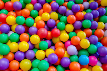 Boy playing on the playground, in the children's maze with balls.
