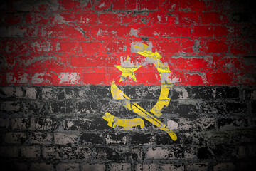 Fototapeta premium Flag of Angola on brick wall