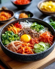 A vibrant bowl of bibimbap featuring fresh vegetables, beef, egg, and spicy sauce, perfect for a healthy and colorful meal.
