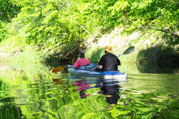 Man and woman couple, in kayak trip rowing boat on the river, water hike, a summer adventure....