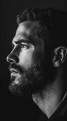 A man with a beard and glasses is looking at the camera