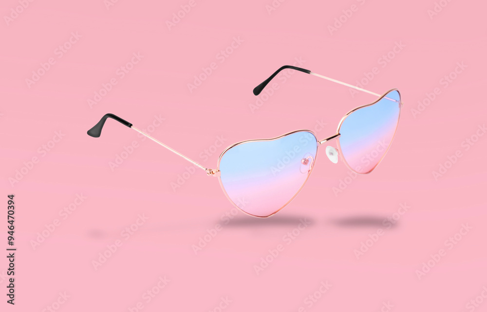 Sticker Stylish sunglasses in air on pink background