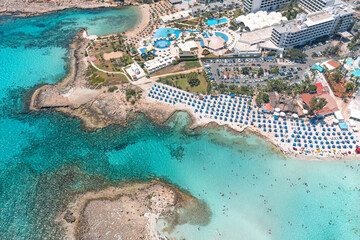 Turquoise water surrounding beachgoers relaxing on the coast of cyprus