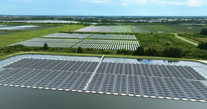 Industrial pond with floating photovoltaic solar panels for producing clean electrical energy. Concept of renewable electricity on water surface with no air pollution