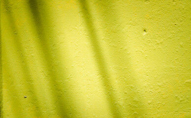 A yellow wall with a shadow on it