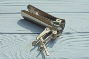 one open iron gray old medical chrome manual vaginal female examination retro speculum lie on ...