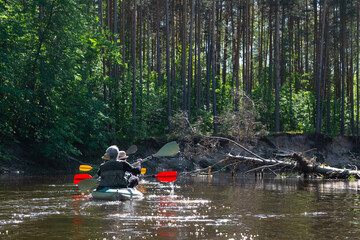 Group kayak trip for seigneur and senora . An elderly couple And adult rowing boat on the river, a water hike, a summer adventure. Age-related sports, mental youth and health, tourism, active old age