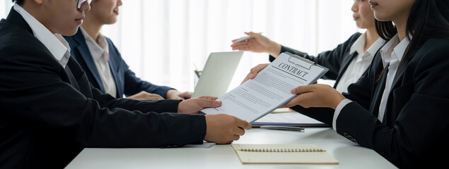 Two business executive in boardroom discuss term and company merging agreement, review corporate...