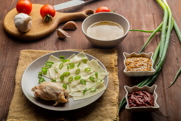 Dagestan khinkal homemade dough, meat, thick broth, garlic and greens