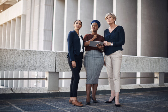 Thinking, diversity or business people on tablet for teamwork for planning, review or feedback meeting. Balcony, empowerment or women in city for networking online, social media update or news agency