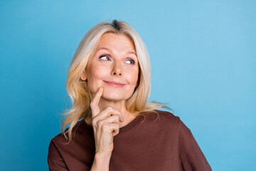 Photo of adorable charming senior woman wear stylish brown clothes look empty space isolated on...