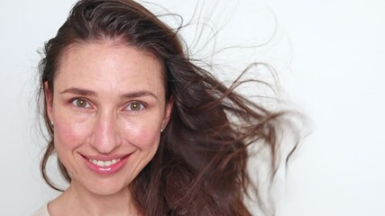 smiling woman using rotative hair brush to arrange or dry hair.isolated girl with beautiful natural hair and dryer in hand. happy satisfied female, advertising banner for care, styling product.