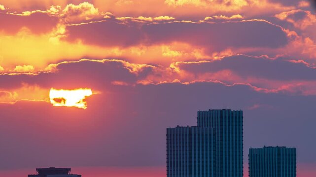 Timelapse of dramatic sunrise with orange sky in a sunny day.