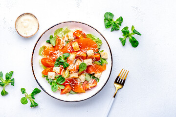 Delicious salad with salmon, iceberg lettuce, croutons, grated parmesan cheese and caesar dressing....