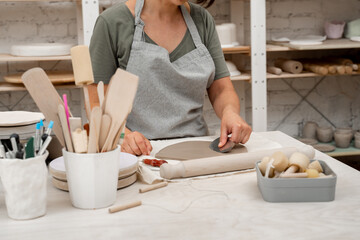 Wedging the clay to eliminate air bubbles. Creating perfect homogenous consistence for ceramics handcraft.