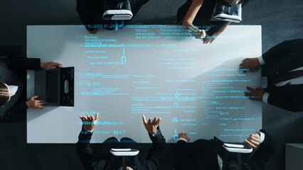Top down aerial view of manager using laptop send data analysis while smart business team wear vr and working in metaverse or virtual program with hologram of coding engineering prompt. Directorate.