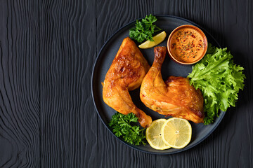 fried chicken legs with lettuce, lemon on plate