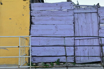 Colorist walls of Colonial house featuring a nice color contrast of purplish-blue and yellow, Calle Maceo Street, Regla municipality. Havana-Cuba-650
