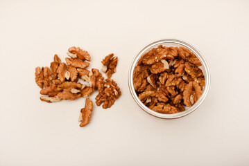 Walnuts in a plastic jar on a white background.