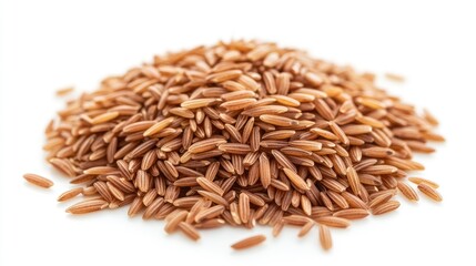 Fototapeta premium Close-up of brown rice grains piled neatly in a small mound on a white background, highlighting their natural texture and color, no people.